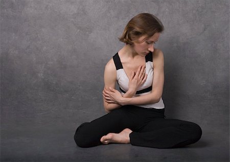 simsearch:400-04047186,k - Sad woman sitting on a floor near concrete wall, studio shot Stock Photo - Budget Royalty-Free & Subscription, Code: 400-05311984