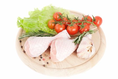 raw chicken on cutting board - Chicken drumsticks with vegetables on the cutting board Stock Photo - Budget Royalty-Free & Subscription, Code: 400-05313620