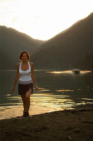 beautiful girl in the background of the mountains goes out to the lake shore Rizza Stock Photo - Budget Royalty-Free & Subscription, Code: 400-05324400