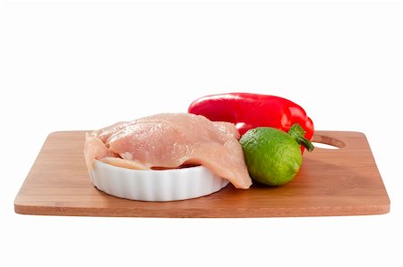 raw chicken on cutting board - Raw chicken breast and vegetables on a cutting board. Stock Photo - Budget Royalty-Free & Subscription, Code: 400-05324450