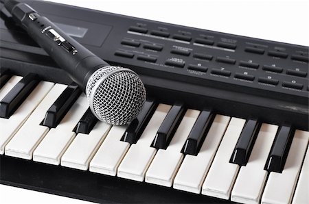 ruslan5838 (artist) - Picture of microphone lying on the keys on a white background Stockbilder - Microstock & Abonnement, Bildnummer: 400-05324572