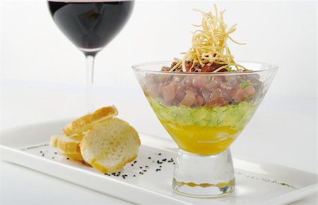 simsearch:400-05324780,k - Appetizer: Raw Tuna, Avocado and Mango in Glass, with Baguette and a Glass of Red Wine (Selective Focus) Photographie de stock - Aubaine LD & Abonnement, Code: 400-05324766