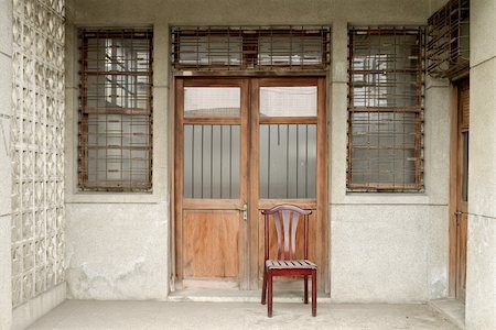 simsearch:400-04702280,k - Nostalgic Chinese old building exterior with door and wall in grungy style and single chair in Taiwan, Asia. Stockbilder - Microstock & Abonnement, Bildnummer: 400-05325651