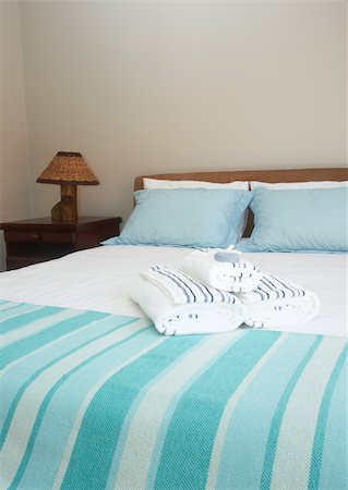 simsearch:400-08155802,k - Beautiful bedroom interior with white sheets and striped towels Foto de stock - Super Valor sin royalties y Suscripción, Código: 400-05325948