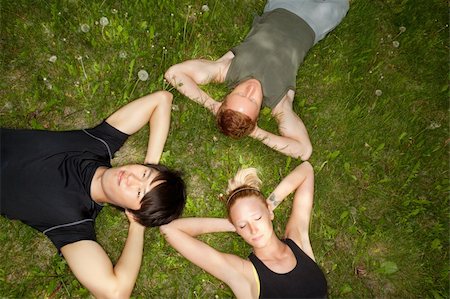 Close-up of friends resting on grass outdoors Stock Photo - Budget Royalty-Free & Subscription, Code: 400-05326379