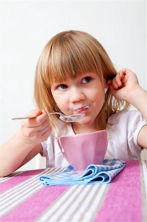 Little girl eating a healthy yoghurt breakfast Stock Photo - Budget Royalty-Free & Subscription, Code: 400-05326682