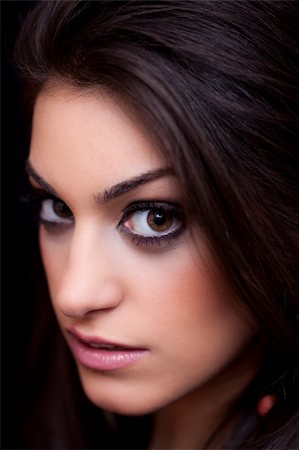 Portrait of a beautiful young woman, close up, on black background, studio shot Foto de stock - Super Valor sin royalties y Suscripción, Código: 400-05327161