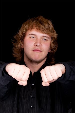 strotter13 (artist) - A young man giving fists to the viewer. Photographie de stock - Aubaine LD & Abonnement, Code: 400-05327184