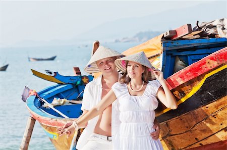 Couple in triangle hats near the boat Stock Photo - Budget Royalty-Free & Subscription, Code: 400-05328139