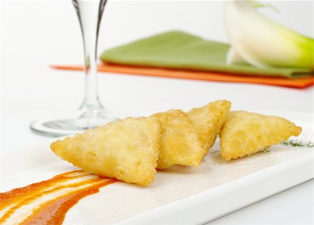 peruvian food gourmet - Appetizer: Empanada de Queso de Cabra (Pasty filled with goat cheese) with sauce, wine glass, napkins and arum lily (Selective Focus) Stock Photo - Budget Royalty-Free & Subscription, Code: 400-05328649