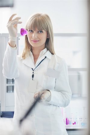 doctor student  female researcher holding up a test tube in chemistry bright labaratory Stock Photo - Budget Royalty-Free & Subscription, Code: 400-05329277