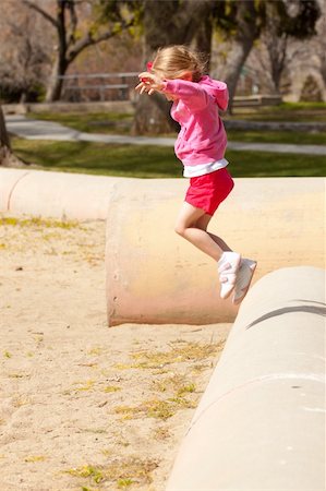 strotter13 (artist) - A great photograph of a young child jumping off of a concrete pipe in the park. Stock Photo - Budget Royalty-Free & Subscription, Code: 400-05329902