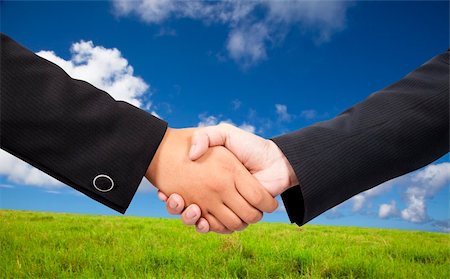 simsearch:400-05672615,k - Close-up of a business people shaking hands against blue sky and green background Foto de stock - Super Valor sin royalties y Suscripción, Código: 400-05320089