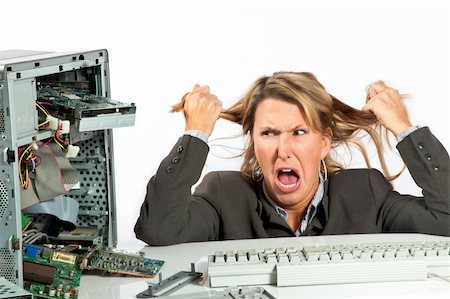 Woman pulls her hair out over her broken computer Stock Photo - Budget Royalty-Free & Subscription, Code: 400-05320180