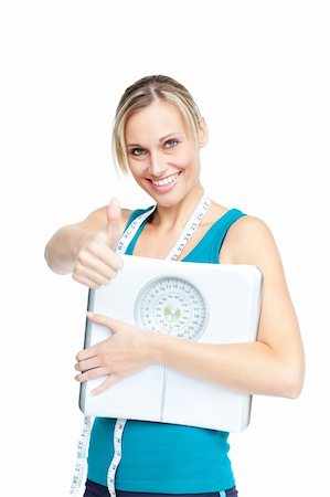 Smiling young woman holding a weight scale looking at the camera over white background Stock Photo - Budget Royalty-Free & Subscription, Code: 400-05320843