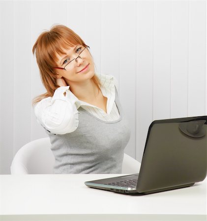 pzromashka (artist) - tired girl with a laptop stretches in the workplace Stock Photo - Budget Royalty-Free & Subscription, Code: 400-05320867