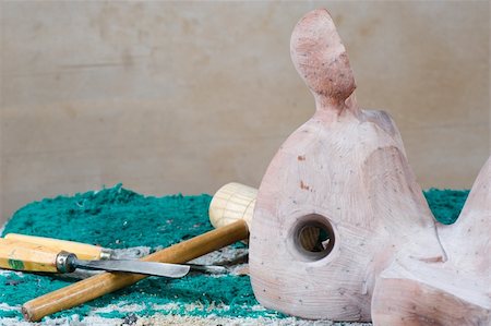 A wooden sculpture surrounded by tools, still life Stock Photo - Budget Royalty-Free & Subscription, Code: 400-05320980