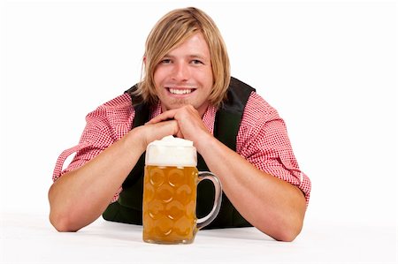 Man with lederhose and oktoberfest beer stein lying on floor. Isolated on white background. Photographie de stock - Aubaine LD & Abonnement, Code: 400-05321300