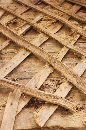 Planks and boards as the armature for clay. A fragment of the old dilapidated mud walls Stock Photo - Budget Royalty-Free & Subscription, Code: 400-05321556
