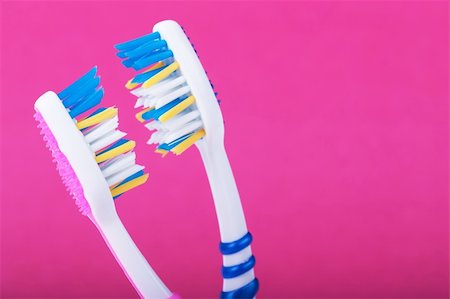 A couple of toothbrushes over pink background Stock Photo - Budget Royalty-Free & Subscription, Code: 400-05323105