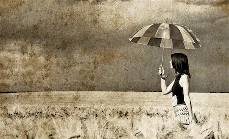 Girl with umbrella at field. Photo in old retro style. Stock Photo - Budget Royalty-Free & Subscription, Code: 400-05323140