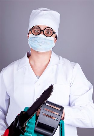 Crazy doctor with portable saw. Studio shot. Stock Photo - Budget Royalty-Free & Subscription, Code: 400-05323271