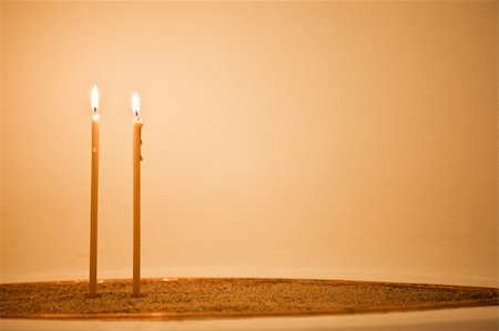 Two candles are burning in church's bowl with send Fotografie stock - Microstock e Abbonamento, Codice: 400-05334526