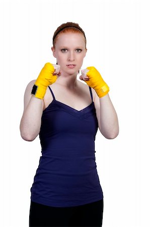 A beautiful young woman wearing a pair of boxing gloves Stock Photo - Budget Royalty-Free & Subscription, Code: 400-05334781