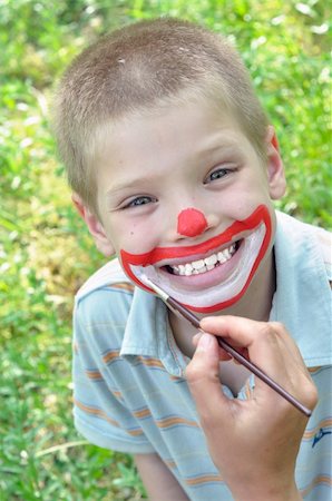 outdoor portrait of a child with his face being painted Photographie de stock - Aubaine LD & Abonnement, Code: 400-05335052