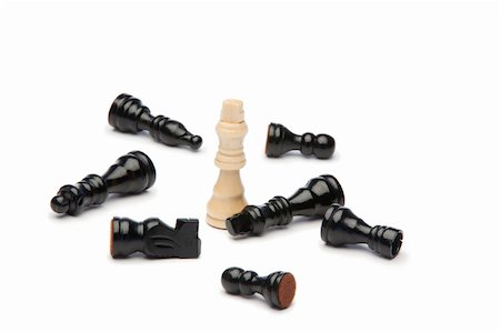 White king and dark pieces of chess on a white background Stock Photo - Budget Royalty-Free & Subscription, Code: 400-05335139