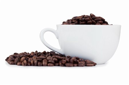 Cup full of coffee beans with coffee beans on the side on a white background Stock Photo - Budget Royalty-Free & Subscription, Code: 400-05335153