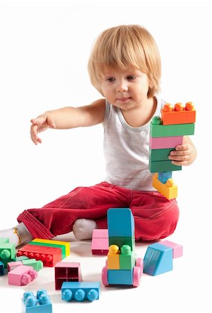 simsearch:400-04161270,k - Cute little boy playing with blocks, isolated on white background Foto de stock - Super Valor sin royalties y Suscripción, Código: 400-05335176