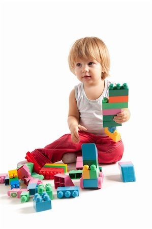 Funny boy playing with blocks, studio shot Stock Photo - Budget Royalty-Free & Subscription, Code: 400-05335177