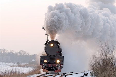Old retro steam train starting from the station during wintertime Stock Photo - Budget Royalty-Free & Subscription, Code: 400-05335570