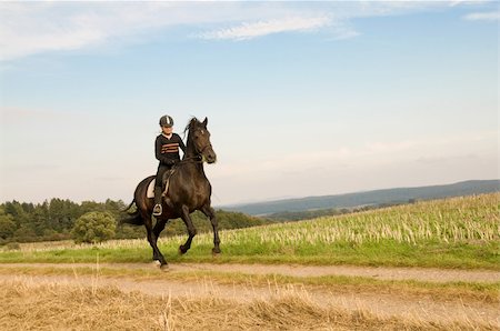 Equestrienne  rides at a gallop on a brown horse. Photographie de stock - Aubaine LD & Abonnement, Code: 400-05335624