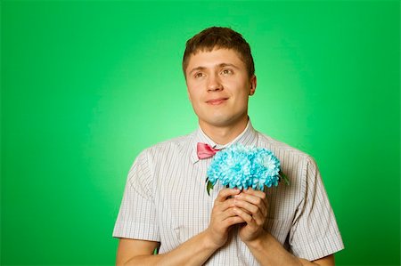 Parody lover man "nerd" in a shirt and tie "butterfly" with a bouquet of flowers blue chrysanthemums Stock Photo - Budget Royalty-Free & Subscription, Code: 400-05335737