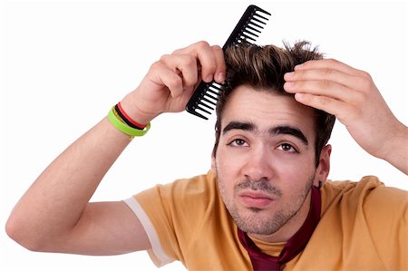 simsearch:400-04323304,k - young man combing his hair with a comb, isolated on white, studio shot Stock Photo - Budget Royalty-Free & Subscription, Code: 400-05335795