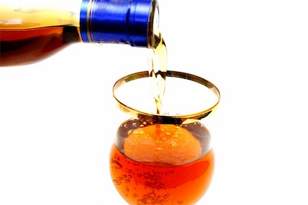 Zoomed bottleneck filling a glass with brown liquid Photographie de stock - Aubaine LD & Abonnement, Code: 400-05335995