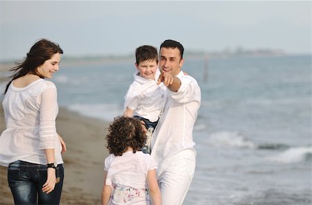 happy young family have fun and live healthy lifestyle on beach Stock Photo - Budget Royalty-Free & Subscription, Code: 400-05336146