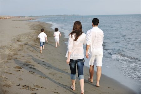 happy young family have fun and live healthy lifestyle on beach Stock Photo - Budget Royalty-Free & Subscription, Code: 400-05336154