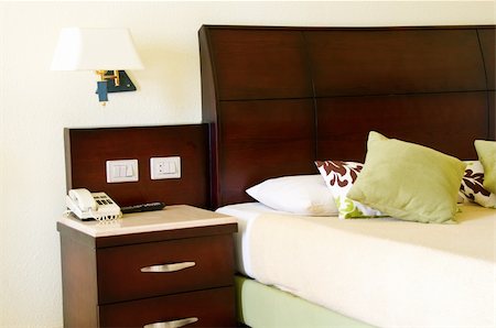 simsearch:400-04873467,k - Hotel bed with green pillows and a telephone on cupboard. Stock Photo - Budget Royalty-Free & Subscription, Code: 400-05336395