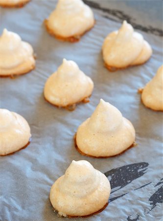 Freshly baked meringue cookies on a baking tray Stock Photo - Budget Royalty-Free & Subscription, Code: 400-05336878