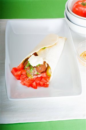 fresh traditional falafel wrap on pita bread with fresh chopped tomatoes Stock Photo - Budget Royalty-Free & Subscription, Code: 400-05337578