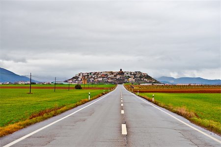 Straight Road Leading to the Medieval Spanish City on a Hill, Rainy Day Stock Photo - Budget Royalty-Free & Subscription, Code: 400-05338115