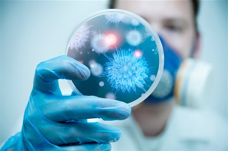 petri dish and hand - A scientist holding a Petri Dish with Virus and bacteria cells. Stock Photo - Budget Royalty-Free & Subscription, Code: 400-05338774