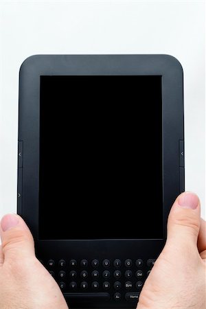 simsearch:400-08501429,k - Hands holding an ebook reader photographed on white background. Black screen Photographie de stock - Aubaine LD & Abonnement, Code: 400-05338800