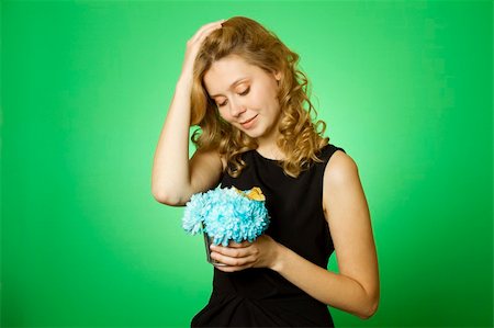 sunny_baby (artist) - Close-up of an attractive young woman holding a gift bouquet of blue chrysanthemums sits on colors yellow butterfly Foto de stock - Royalty-Free Super Valor e Assinatura, Número: 400-05338936