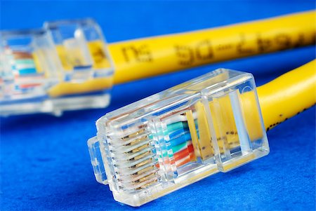 Close-up view of the yellow Ethernet (RJ45) network cable isolated on blue Stock Photo - Budget Royalty-Free & Subscription, Code: 400-05339734
