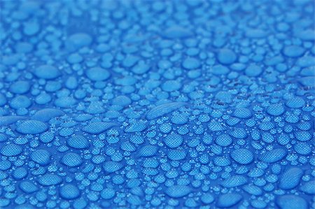 roxxer (artist) - Closeup view of water drops on a blue fabric background Fotografie stock - Microstock e Abbonamento, Codice: 400-05339936