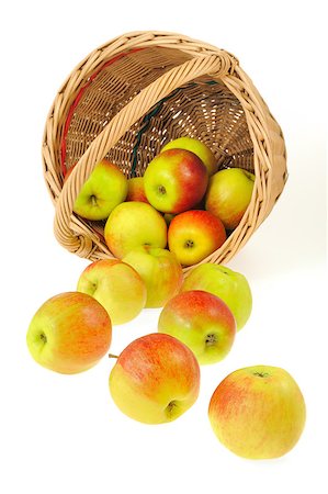 simsearch:400-04611875,k - Fresh apples spilling out of basket - isolated on white background. Clipping path included. Photographie de stock - Aubaine LD & Abonnement, Code: 400-05339943